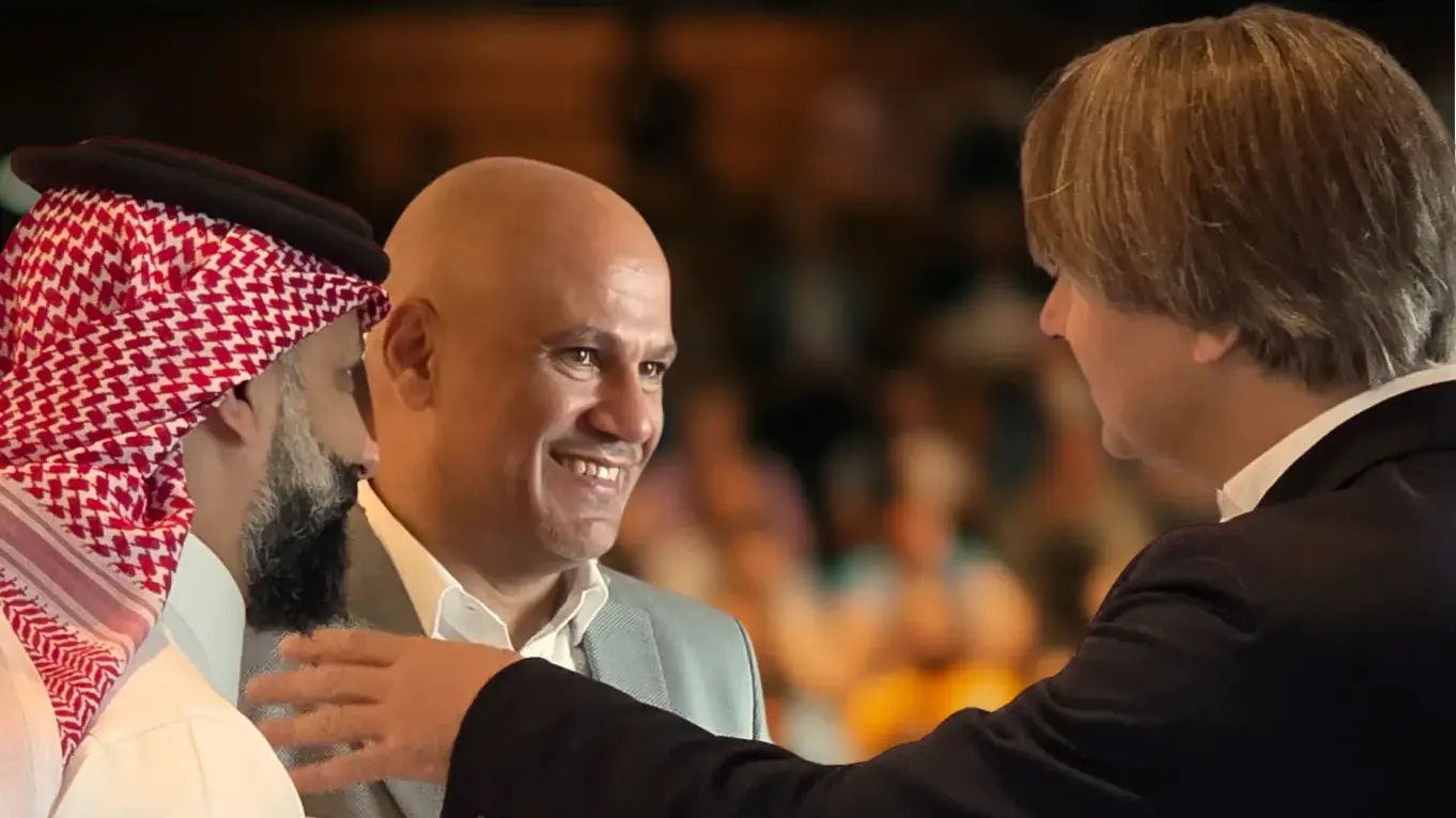Imre van Gastel speaking with leaders at an event